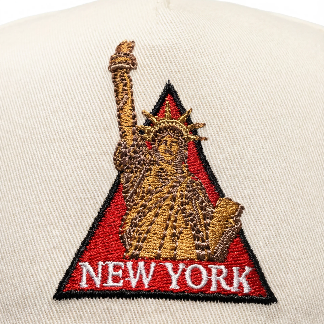 Statue of Liberty NYC hat side — navy Zoleado signature on cream side panel
