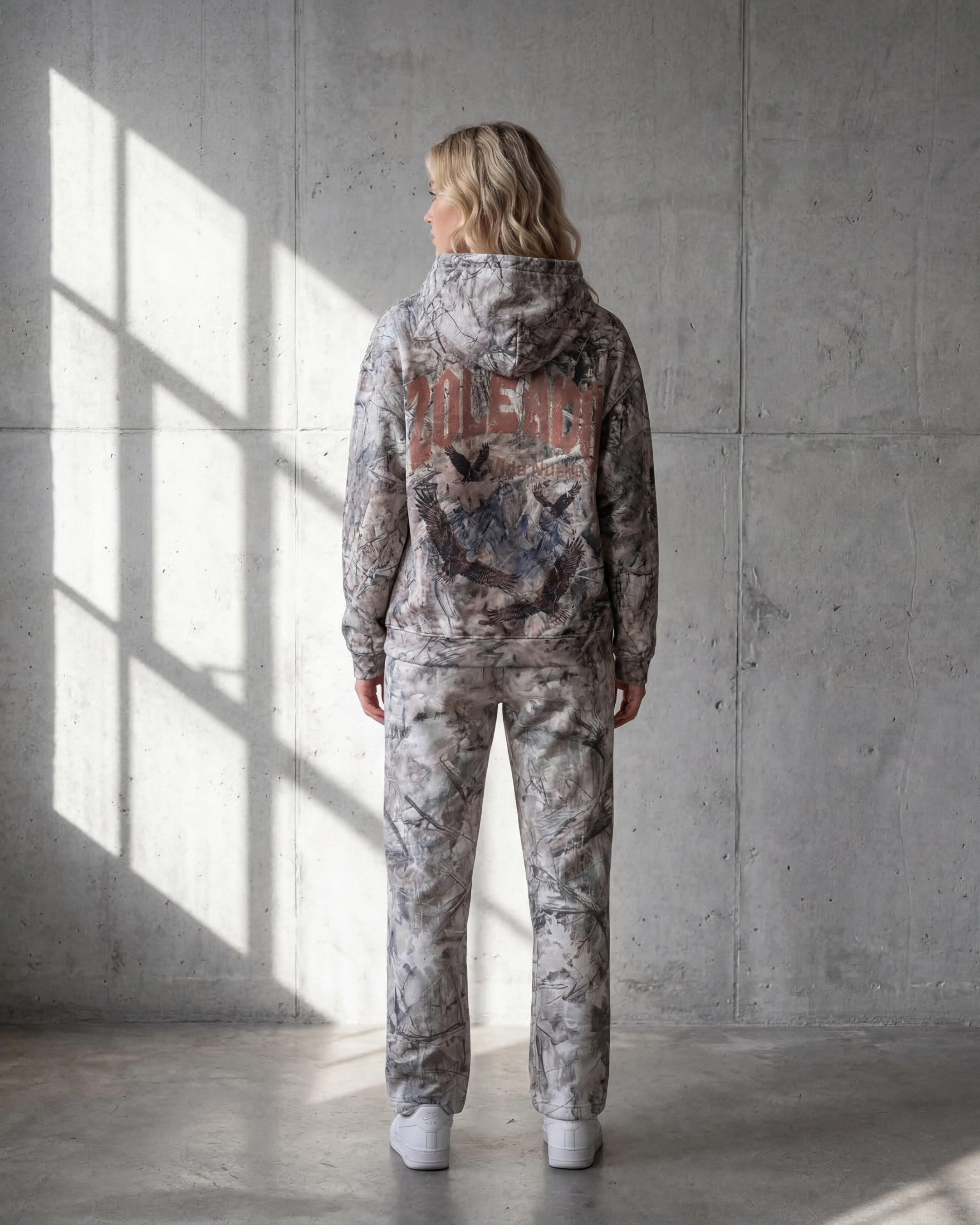 Zoleado Camo Hoodie featuring green and brown camouflage pattern, soft fabric, and adjustable drawstring hood.
