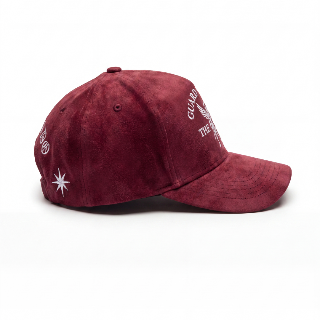 Guard the Flame hat side profile — oxblood suede curved-brim cap, snapback closure