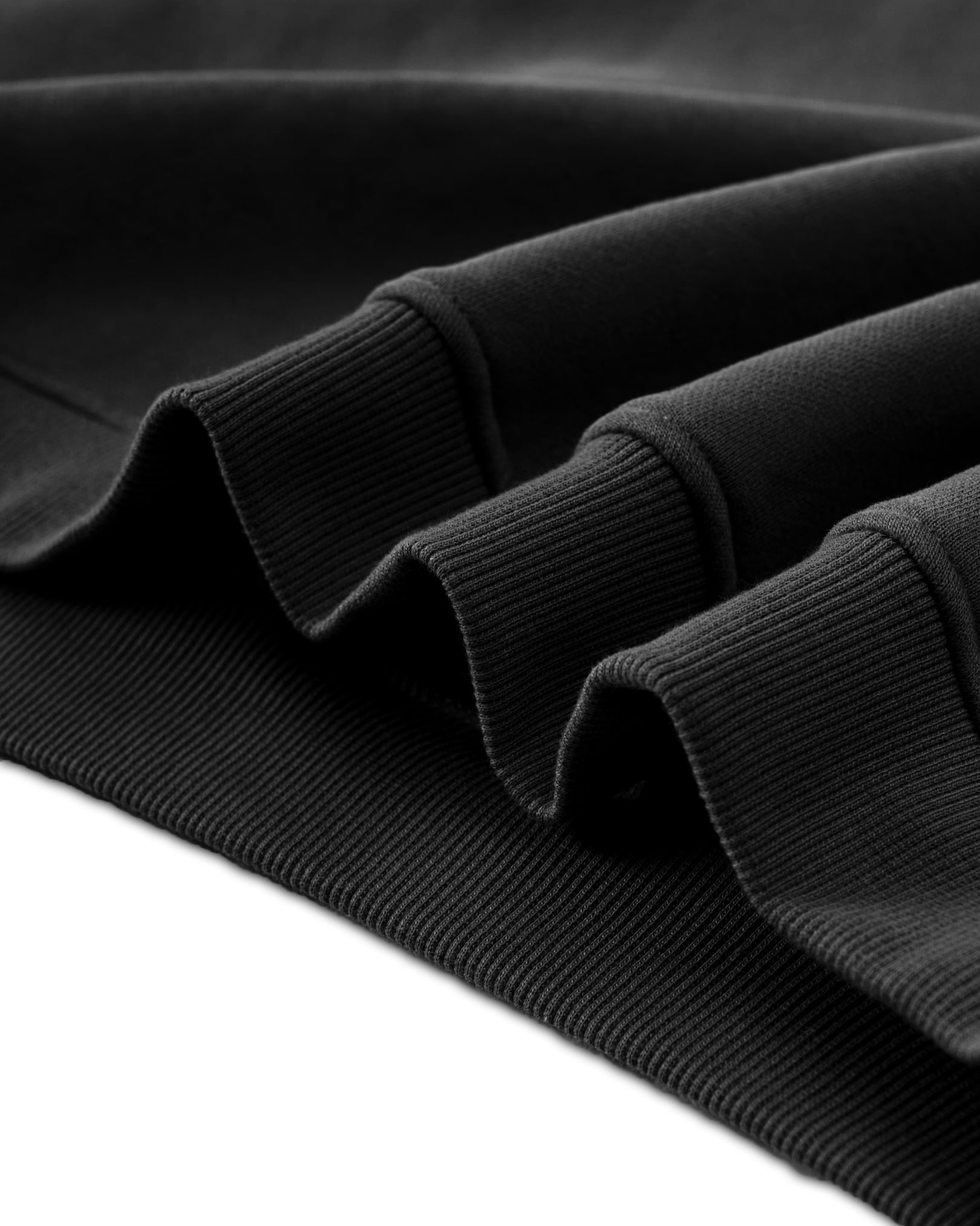 Close-up of a black Baylor University hoodie with ribbed cuffs and hem on a white background