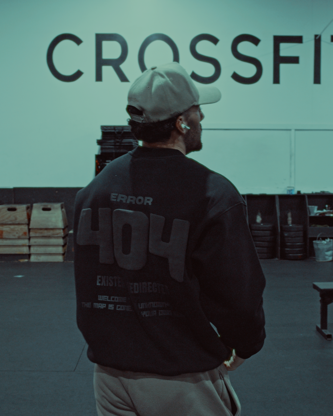 hot male model wearing an LA hat wearing a black zoleado puff print crewneck the back reads 'Error 404'