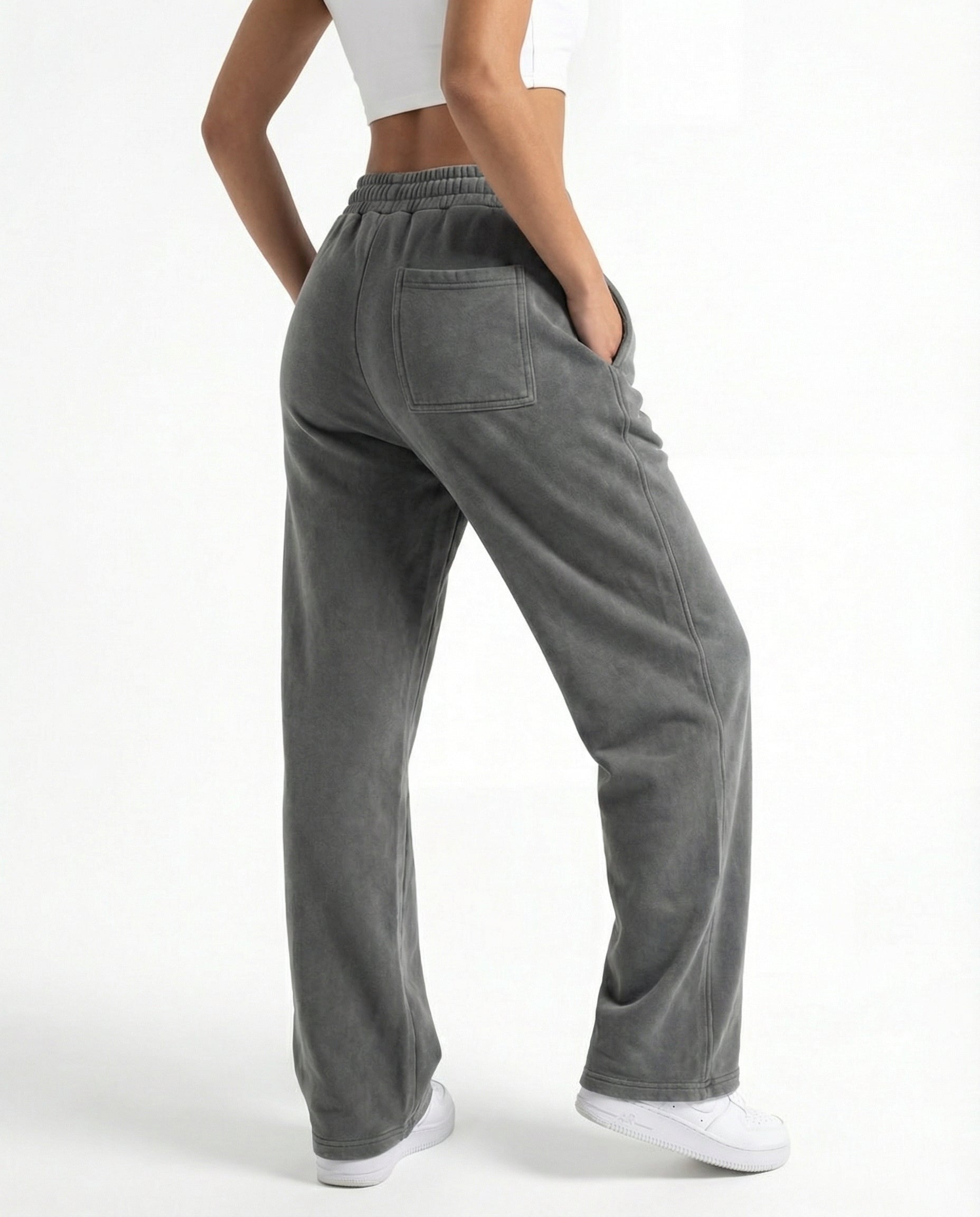 Person wearing gray wide-leg pants on a white background