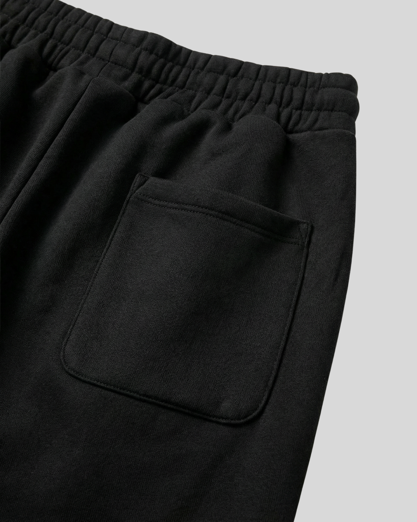 Black pants with a pocket on a light gray background