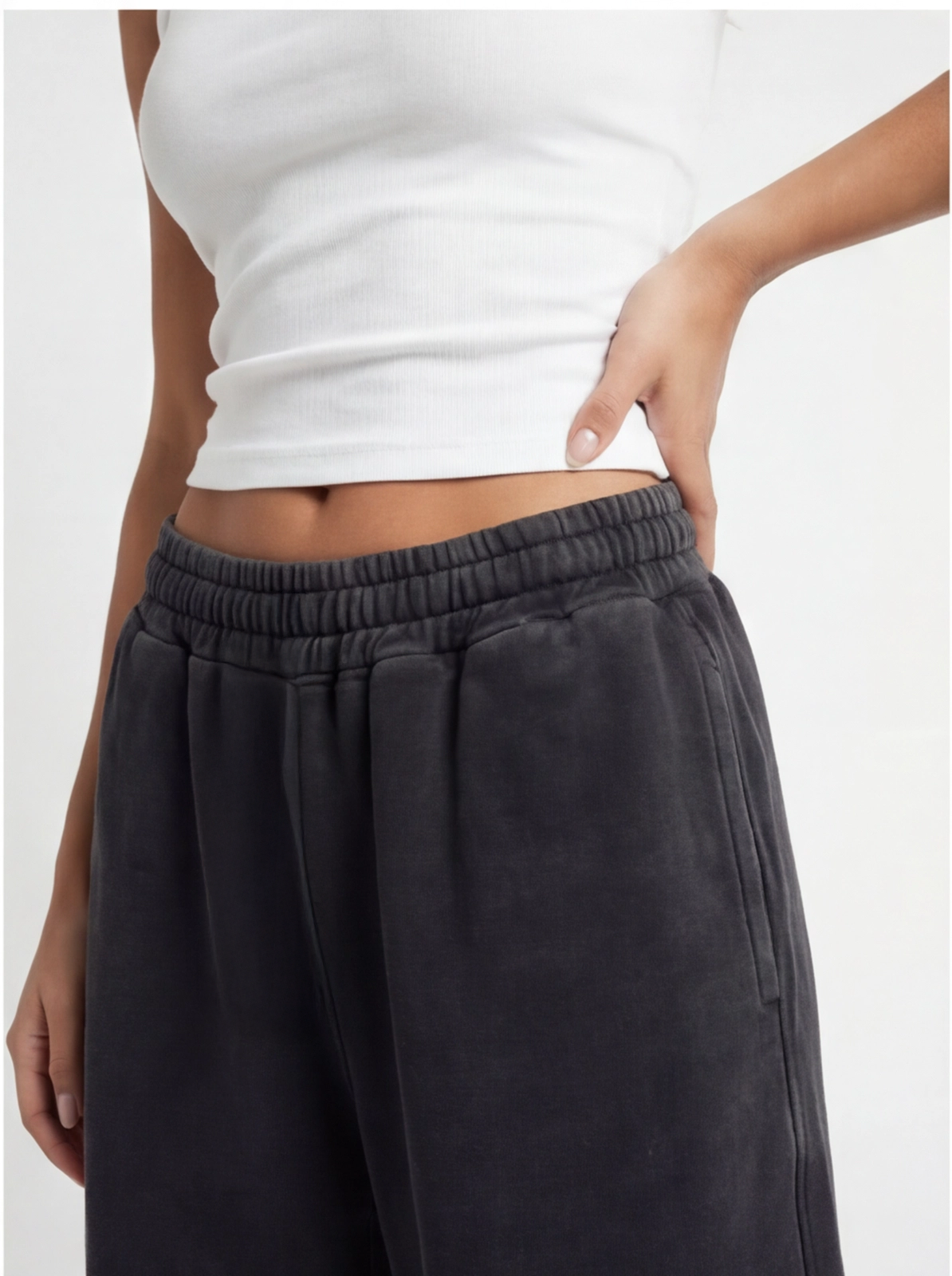 Close-up of black acid wash sweatpants fabric and pocket detail