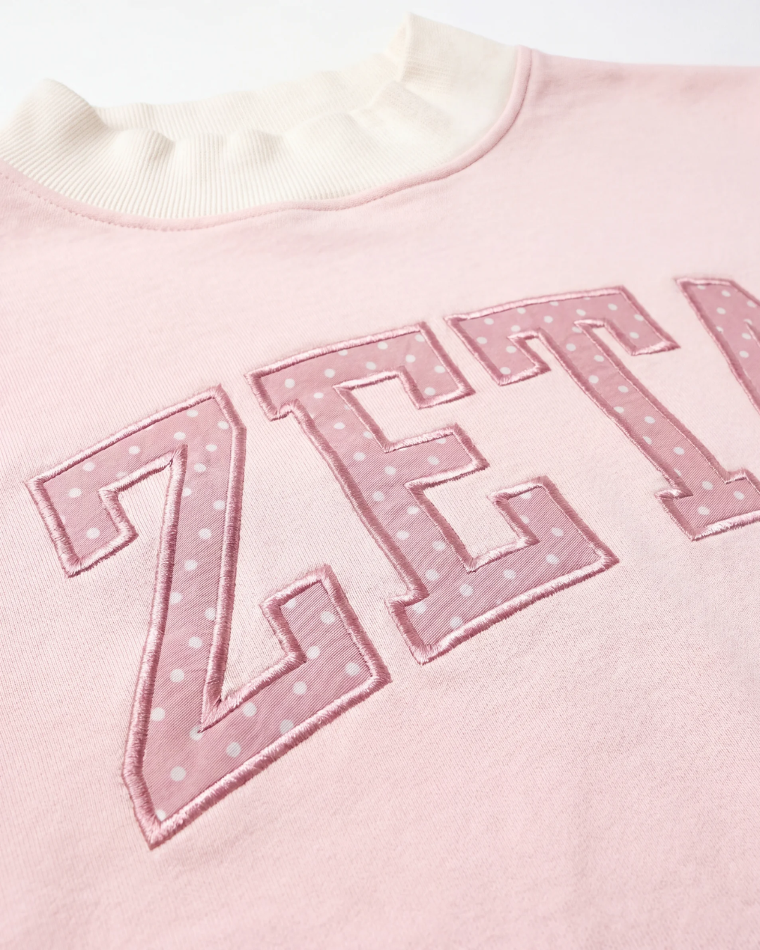 Zeta Mockneck Top ZETA chest embroidery close-up