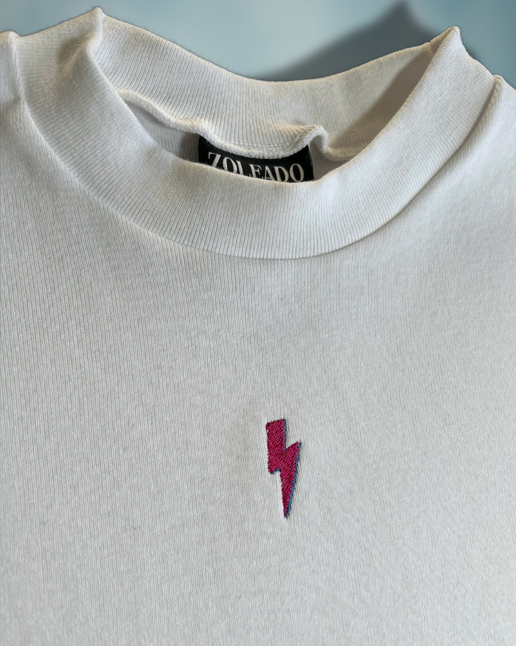 Tiny Spark Baby Tee – Embroidered Pink Lightning Bolt