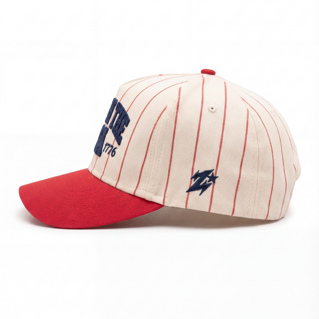 Born in the USA hat side — red pinstripes and navy Zoleado signature on cream side panel