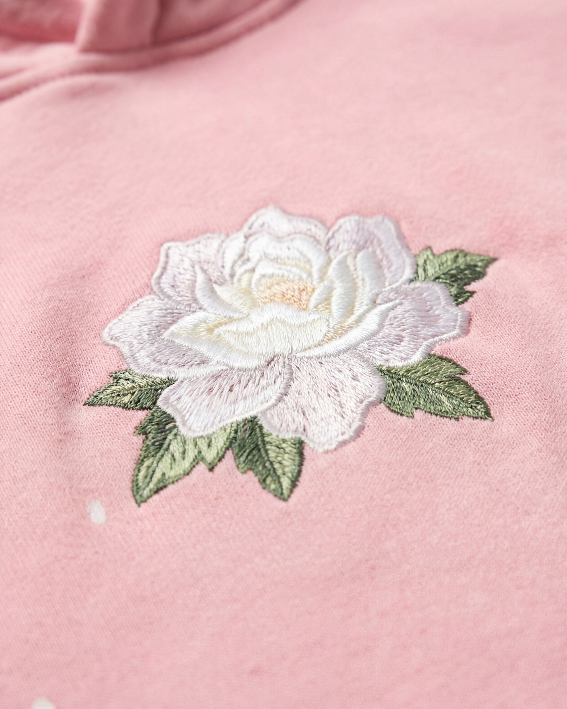 Close-up of camellia flower embroidery on hoodie