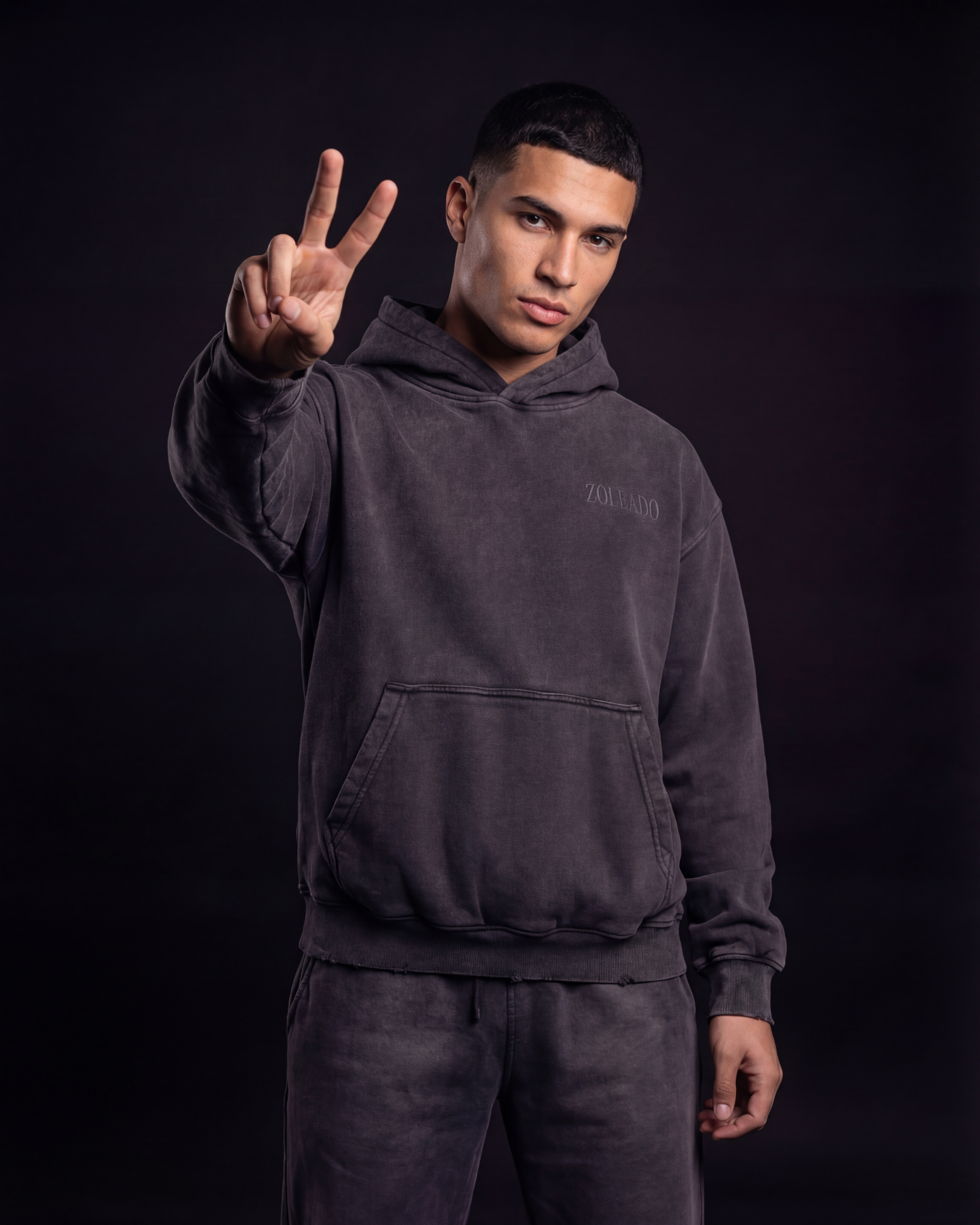 Zoleado Shadow Wash Hoodie featuring a relaxed fit, shadow wash design, and ribbed cuffs on a casual, comfortable hoodie.