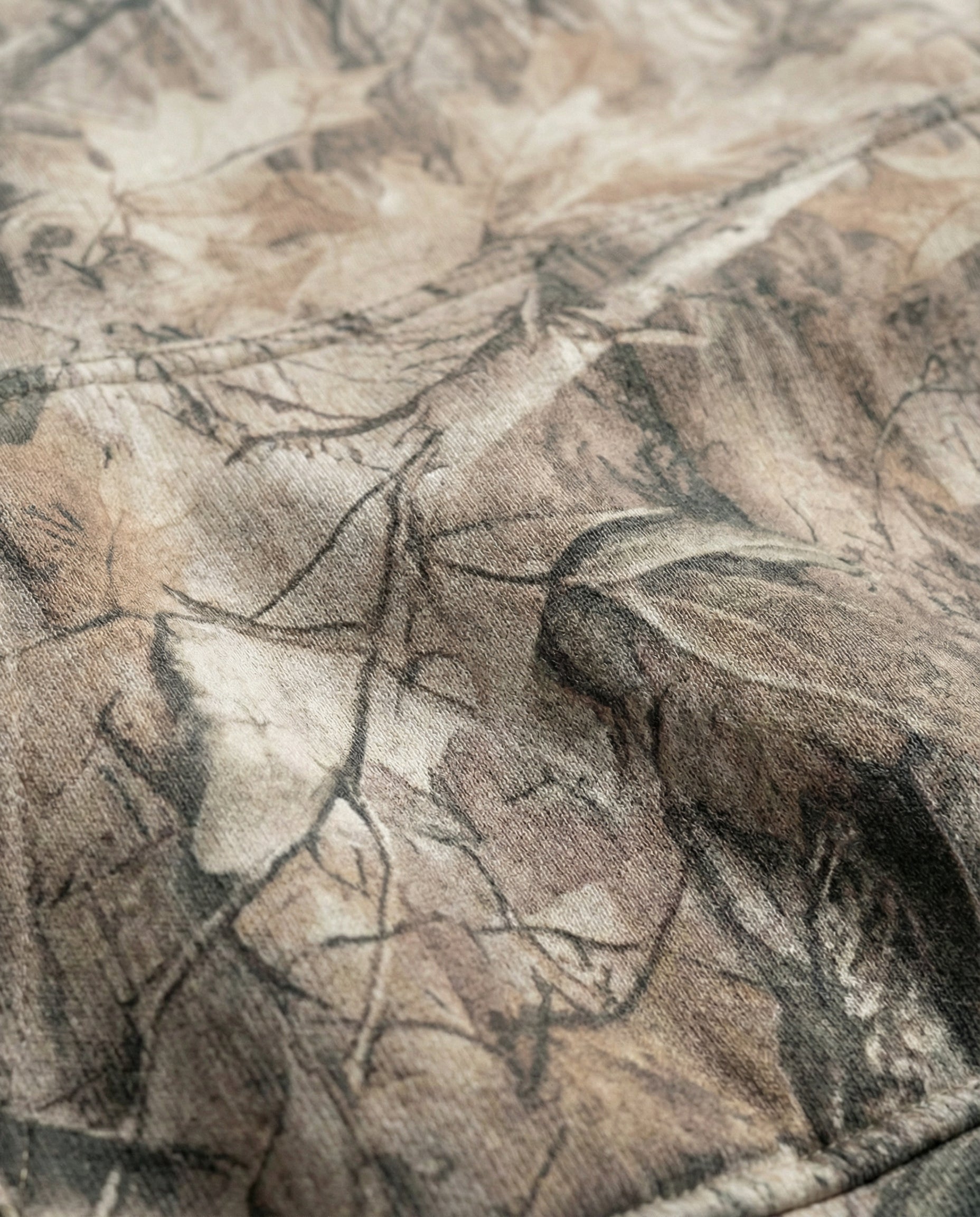 Close-up of camouflage fabric with brown and black pattern on Baylor McLane Stadium hoodie