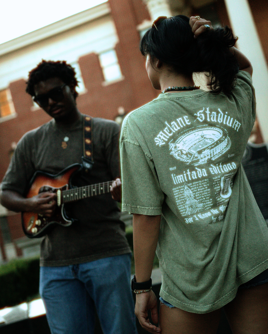 6'3 Male Large, 5'4 Girl Medium.
black guy holding a guitar with a girl. Mclane Shirt