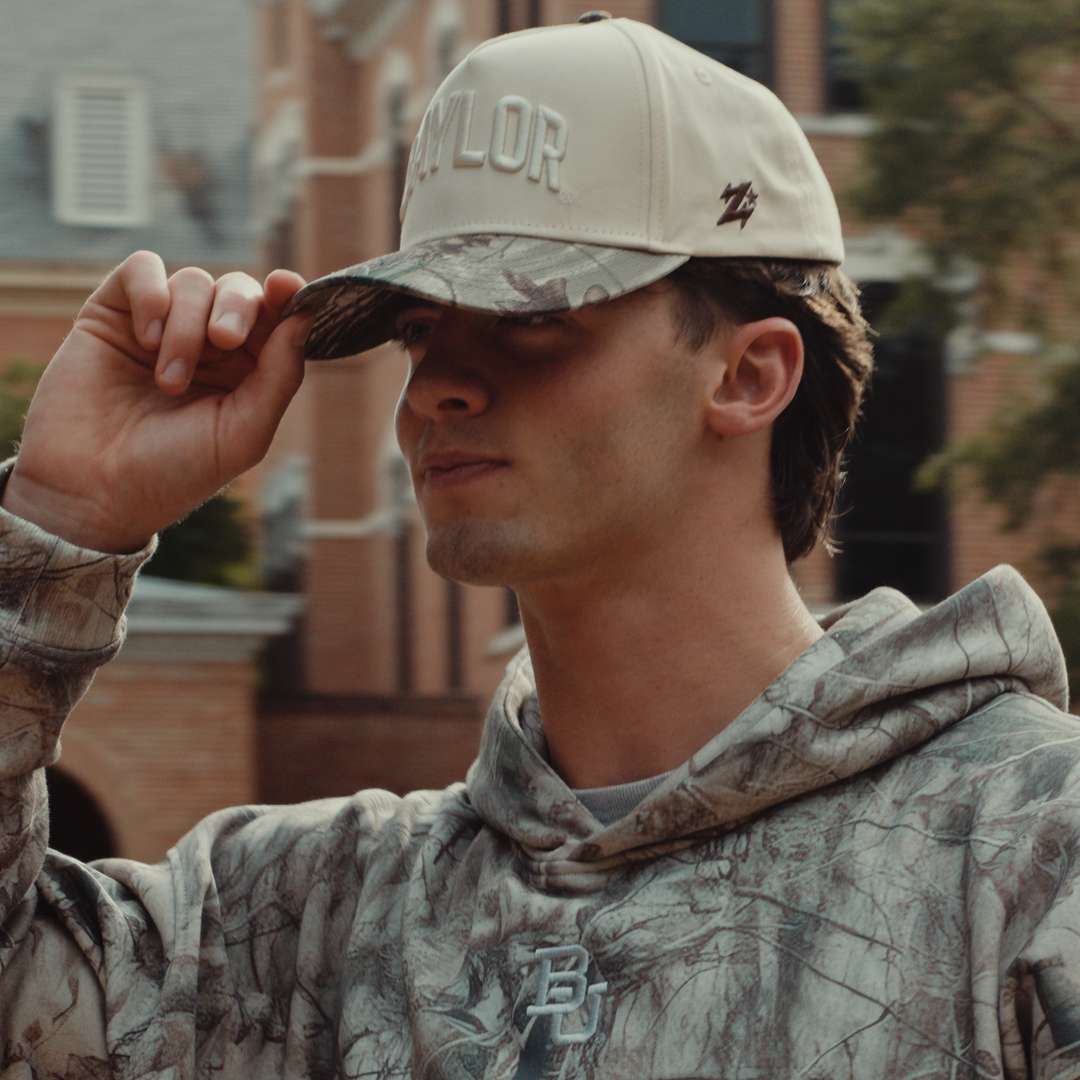 Baylor Bears Texas camo hat worn — model in cream and woodland camo Baylor baseball cap