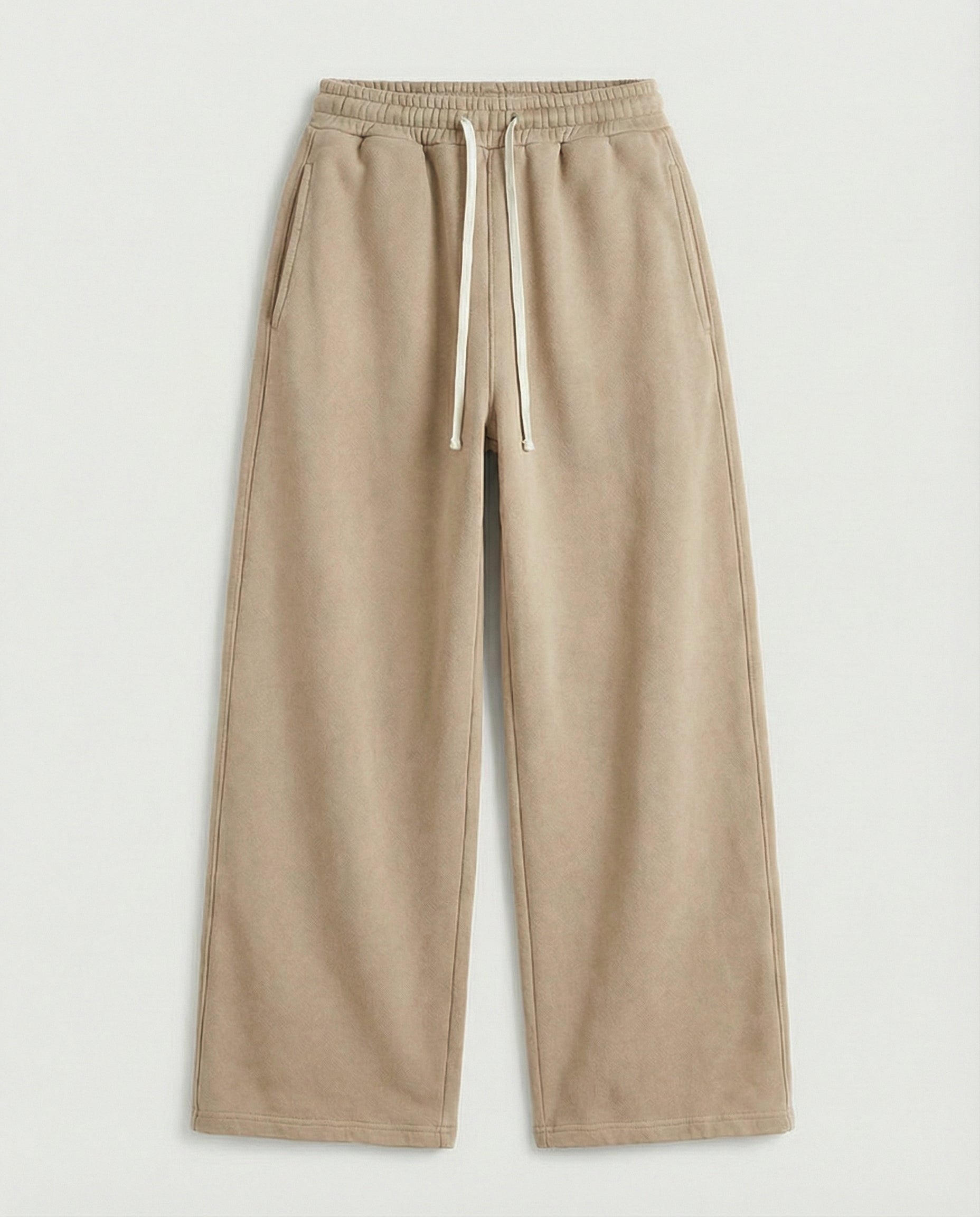 Beige sweatpants with a drawstring on a light gray background