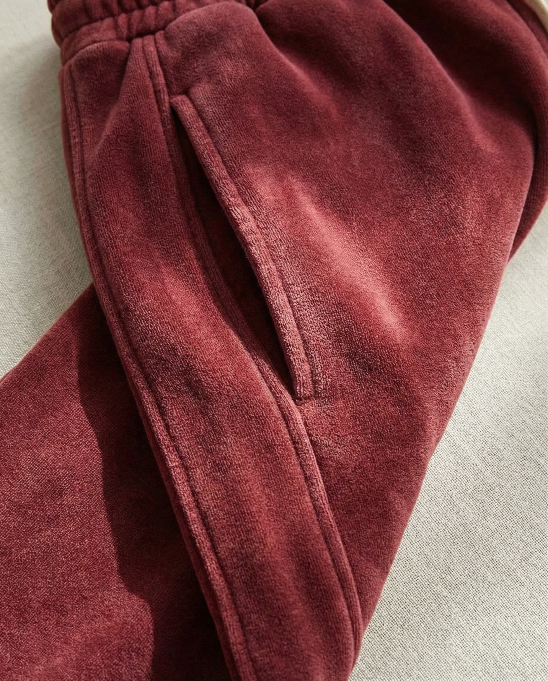 Close-up of red velvet fabric on a light gray background