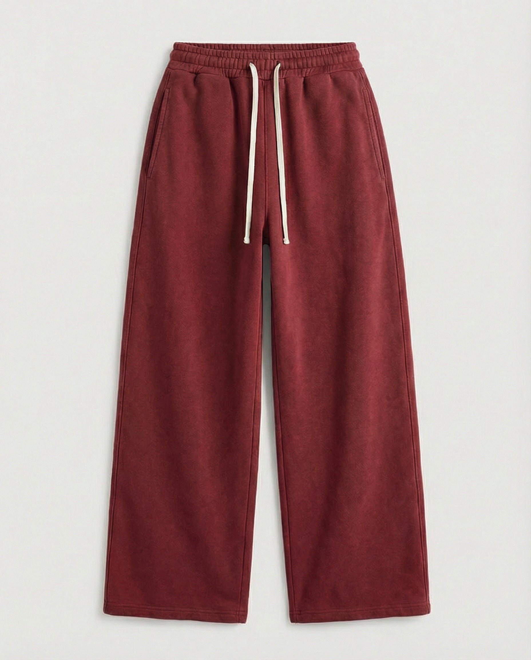 red sweatpants with a white drawstring on a light gray background