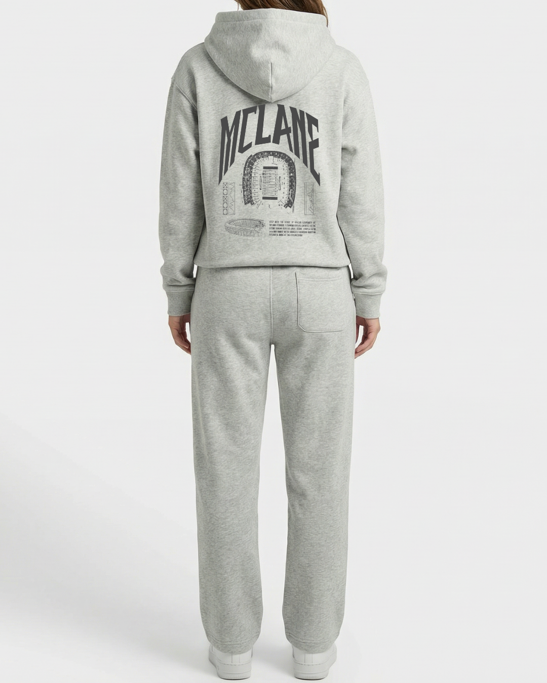 Person wearing a gray hoodie and pants with 'McLane' branding on a white background