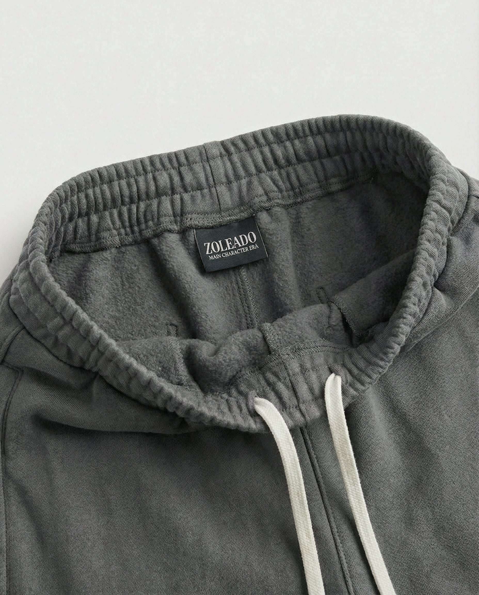 Close-up of gray acid wash sweatpants fabric and pocket detail