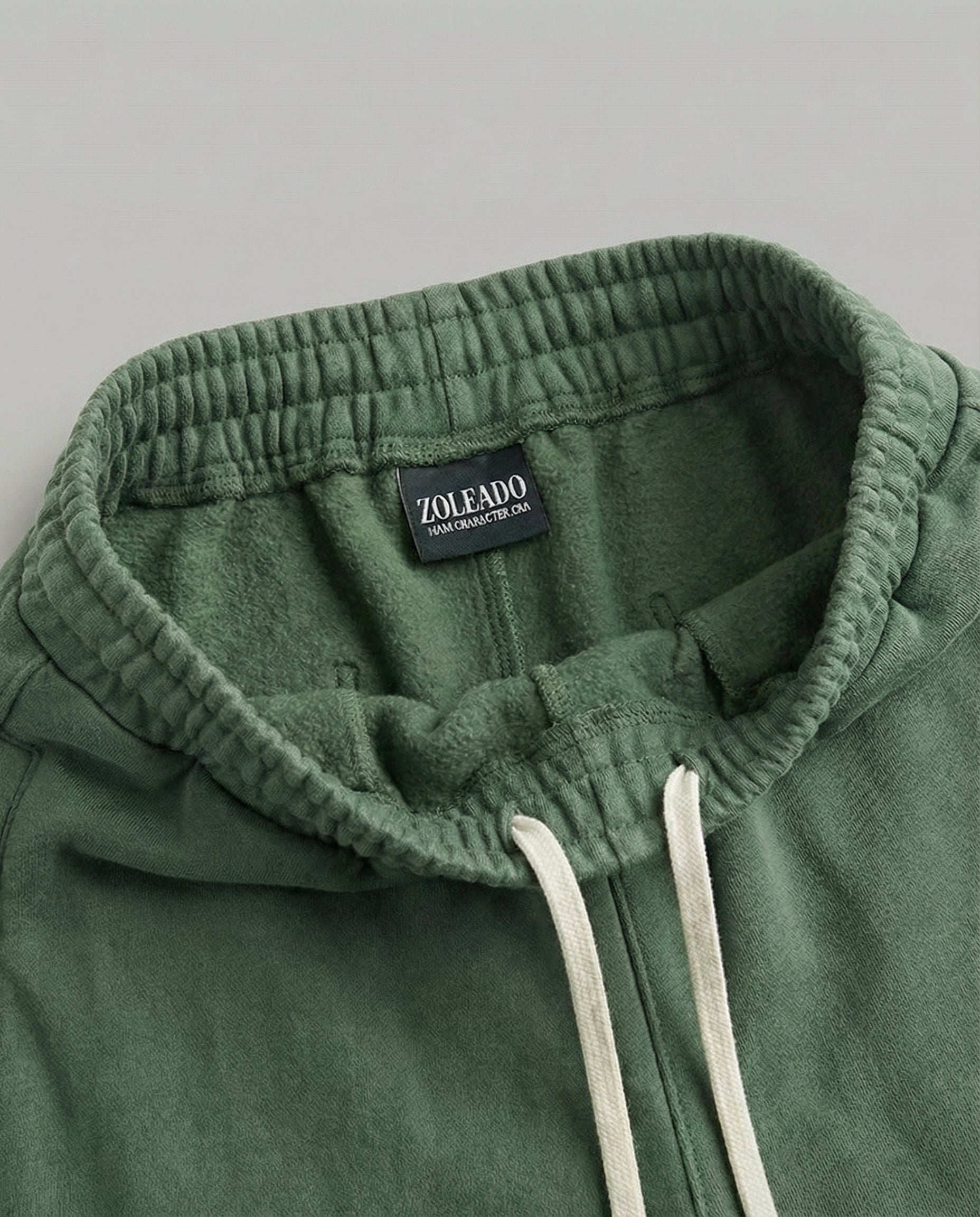 Close-up of forest acid wash sweatpants fabric and pocket detail