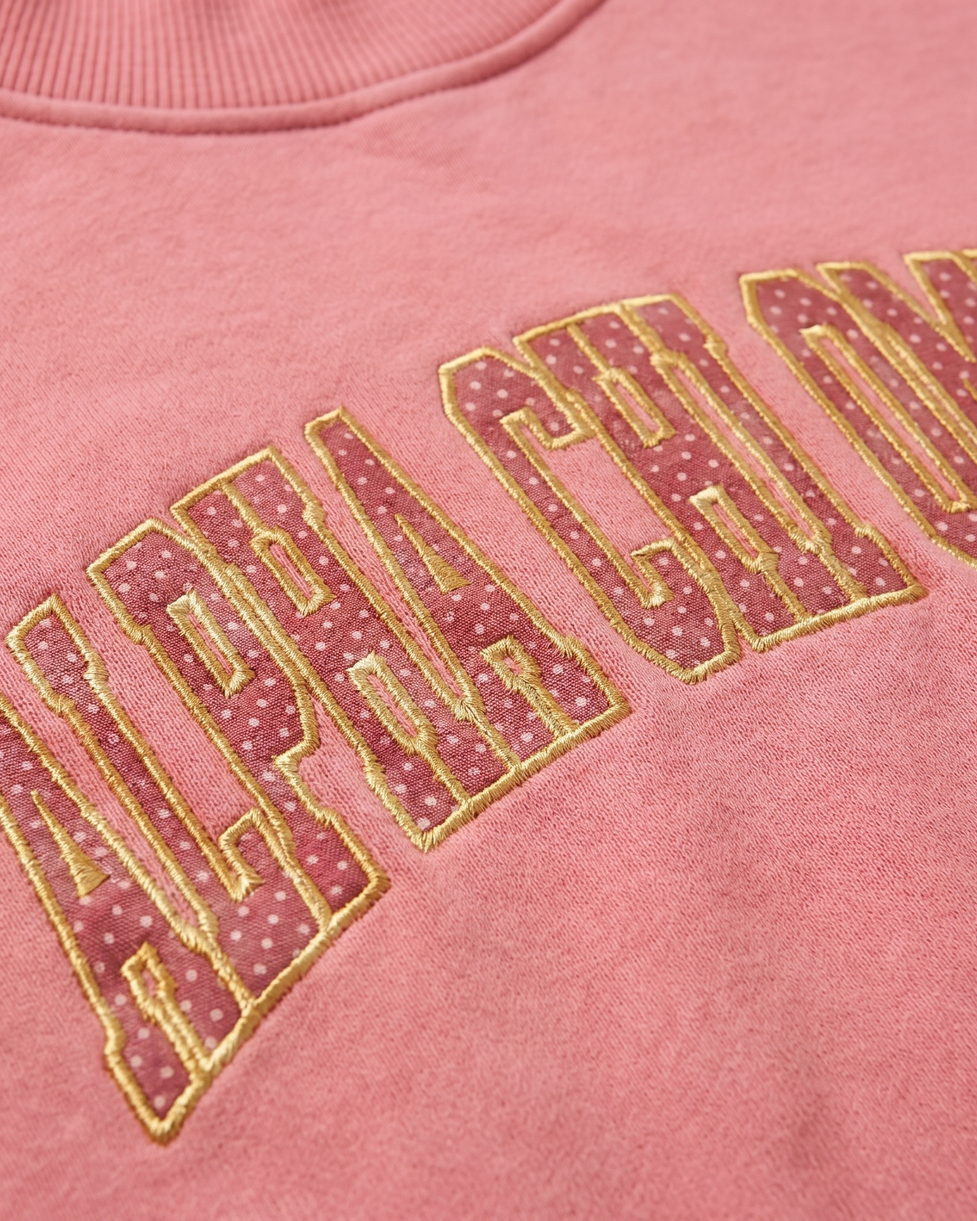 Alpha Chi Omega chest patch embroidery close-up - raspberry polka-dot tackle-twill with gold outline