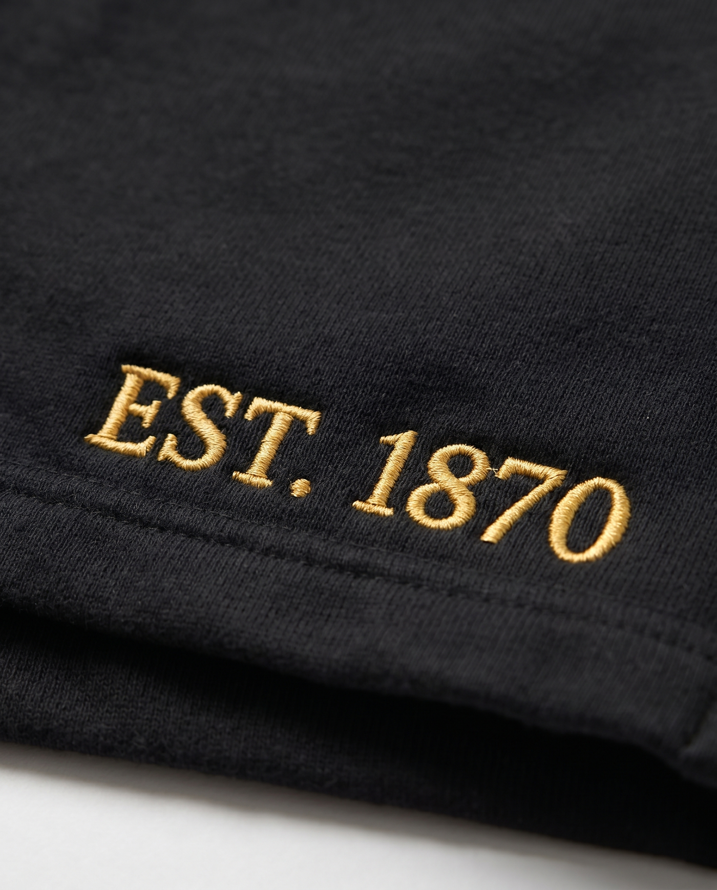 Kappa Alpha Theta Shorts EST. 1870 leg embroidery close-up in gold on black cotton fleece