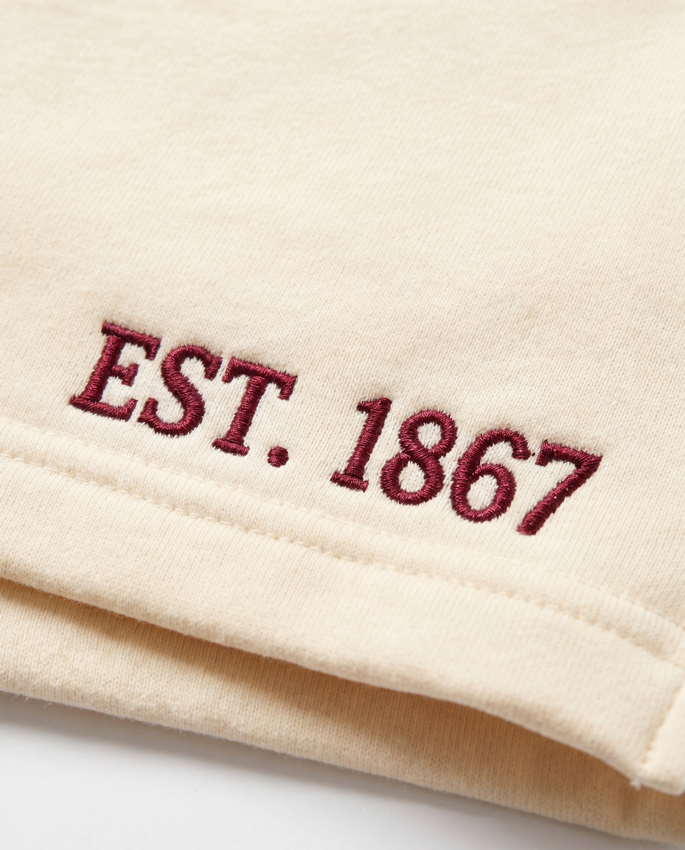 Pi Beta Phi Shorts EST. 1867 leg embroidery close-up in wine on cream cotton fleece